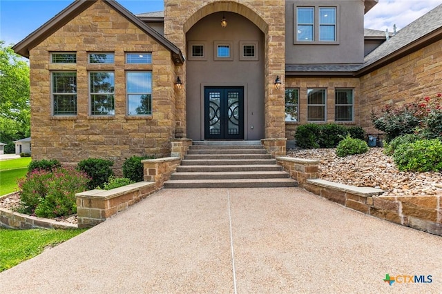 1605 Altavista Loop, Temple, TX 76502 - doorway to property with french doors, stone siding, and stucco siding