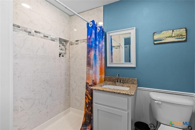 1605 Altavista Loop, Temple, TX 76502 - full bathroom with a tile shower, vanity, toilet, and a wainscoted wall