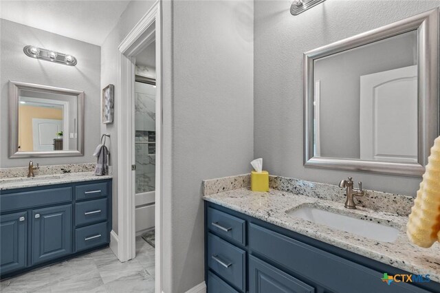 1605 Altavista Loop, Temple, TX 76502 - bathroom with marble finish floors, two vanities, and shower / washtub combination
