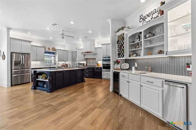1605 Altavista Loop, Temple, TX 76502 - kitchen featuring open shelves, appliances with stainless steel finishes, beverage cooler, light countertops, and recessed lighting
