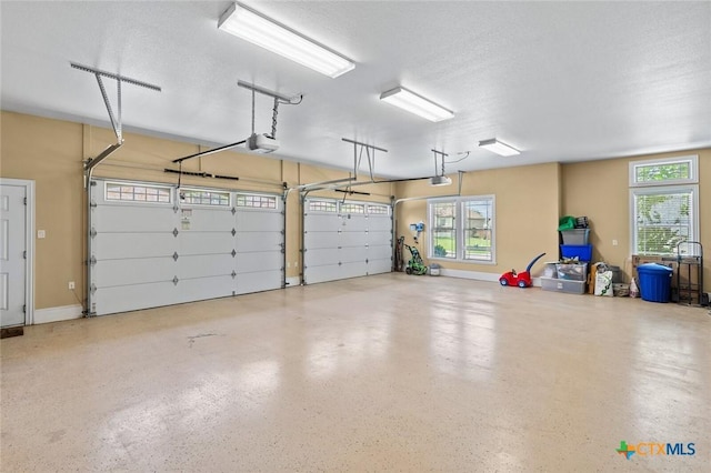 1605 Altavista Loop, Temple, TX 76502 - garage with a garage door opener and baseboards