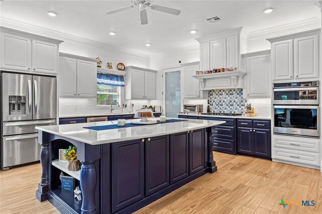 1605 Altavista Loop, Temple, TX 76502 - kitchen featuring stainless steel appliances, a kitchen island, open shelves, blue cabinetry, and light countertops