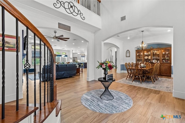 1605 Altavista Loop, Temple, TX 76502 - foyer entrance with arched walkways, a ceiling fan, wood finished floors, baseboards, and recessed lighting