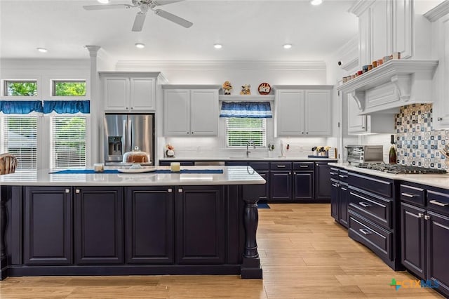 1605 Altavista Loop, Temple, TX 76502 - kitchen with appliances with stainless steel finishes, a kitchen island, light countertops, ceiling fan, and white cabinetry
