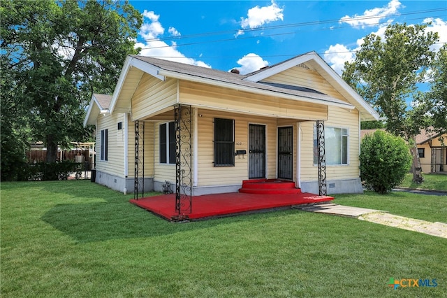 bungalow-style home with a porch and a front lawn