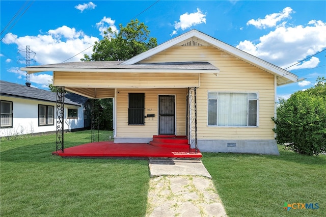 bungalow-style house with covered porch and a front lawn