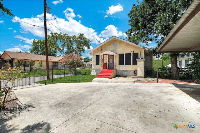 bungalow-style home with a front yard