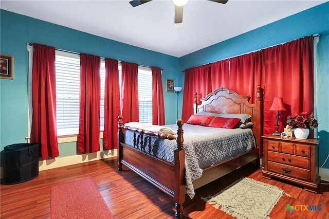 bedroom with hardwood / wood-style floors and ceiling fan