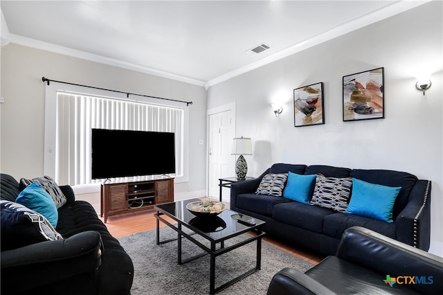 living room featuring wood-type flooring and ornamental molding