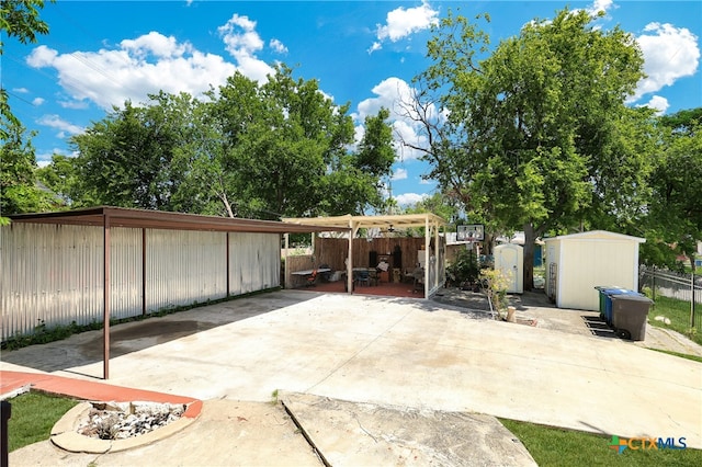 view of patio featuring a storage shed and a carport