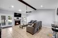 living room featuring a fireplace and ceiling fan