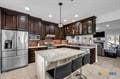 kitchen featuring a kitchen island, dark brown cabinetry, and stainless steel fridge