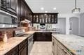 kitchen featuring dark brown cabinets and decorative light fixtures