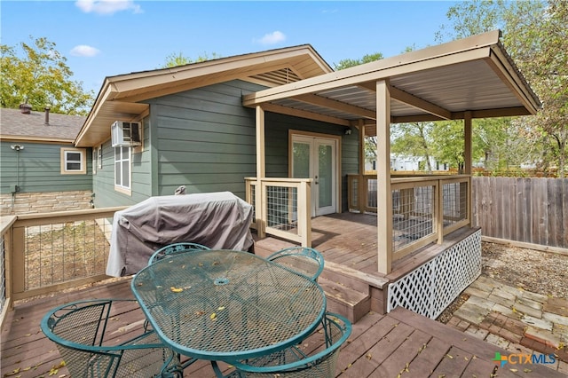 wooden deck featuring a grill