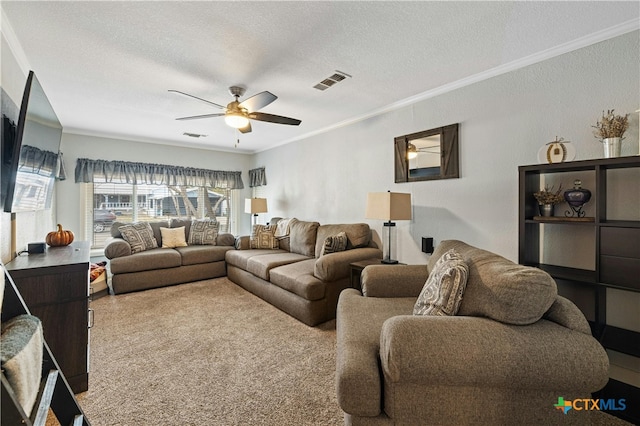 living room featuring ceiling fan, a textured ceiling, crown molding, and carpet floors