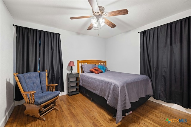 bedroom featuring ceiling fan and light hardwood / wood-style flooring