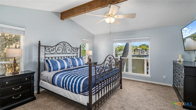 carpeted bedroom with vaulted ceiling with beams, ceiling fan, and a textured ceiling