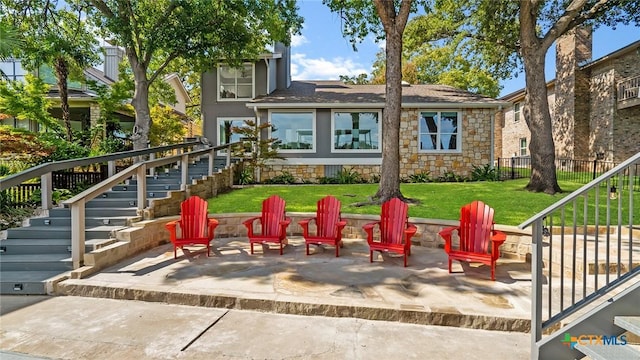 exterior space featuring a fire pit, a yard, and a patio