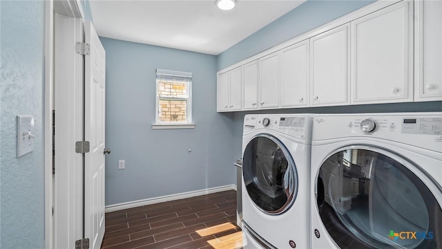 laundry area with cabinets, dark hardwood / wood-style flooring, and separate washer and dryer