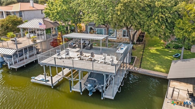 dock area featuring a lawn and a water view