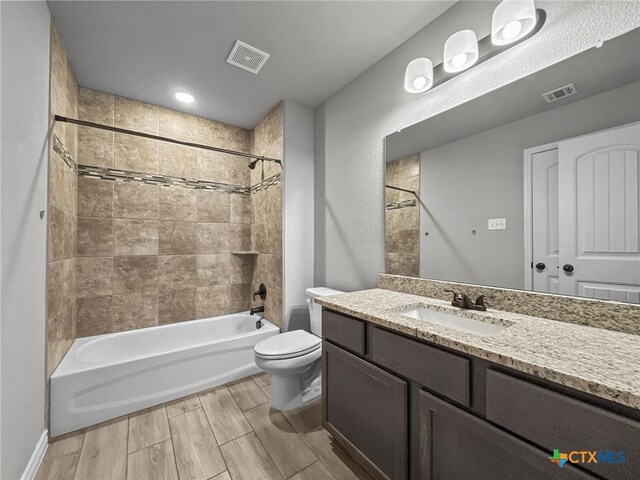 5205 Colina Dr, Killeen, TX 76549 - bathroom with vanity, shower / washtub combination, toilet, and wood finished floors