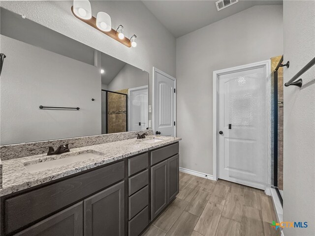5205 Colina Dr, Killeen, TX 76549 - full bathroom featuring a stall shower, double vanity, wood finished floors, and baseboards