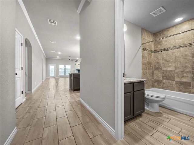 5205 Colina Dr, Killeen, TX 76549 - corridor with wood tiled floors, arched walkways, crown molding, and baseboards