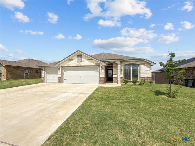 5205 Colina Dr, Killeen, TX 76549 - french provincial home with a front lawn, a garage, concrete driveway, brick siding, and a shingled roof