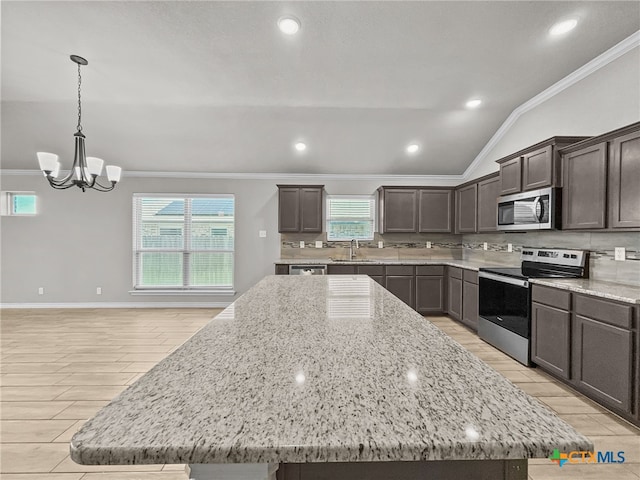 5205 Colina Dr, Killeen, TX 76549 - kitchen featuring stainless steel appliances, crown molding, tasteful backsplash, light wood-type flooring, and a center island
