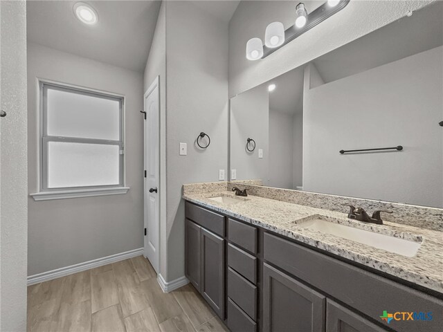 5205 Colina Dr, Killeen, TX 76549 - bathroom featuring double vanity, baseboards, and wood finished floors