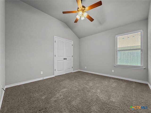 5205 Colina Dr, Killeen, TX 76549 - unfurnished room featuring lofted ceiling, ceiling fan, dark colored carpet, and baseboards