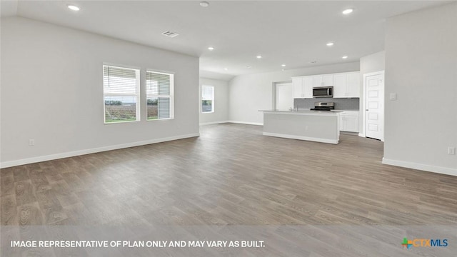 unfurnished living room with hardwood / wood-style floors