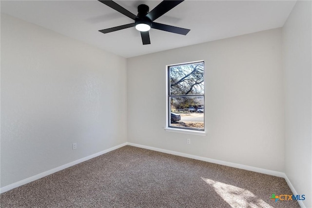 unfurnished room featuring ceiling fan and carpet flooring