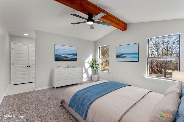 carpeted bedroom with ceiling fan, a closet, and lofted ceiling with beams