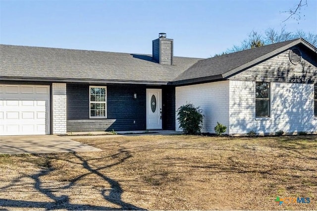 ranch-style home featuring a front yard and a garage