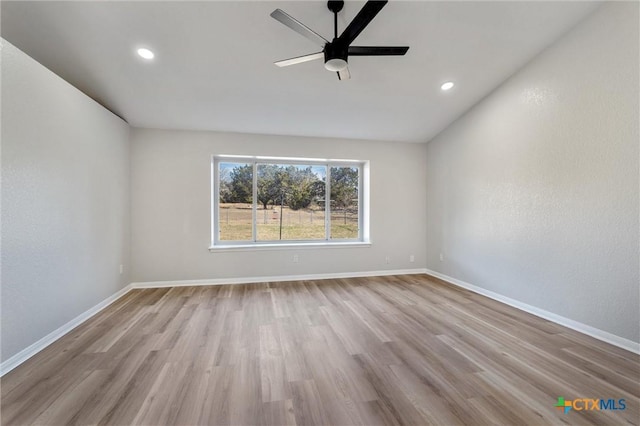 spare room featuring ceiling fan and light wood-type flooring