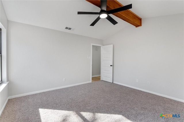 spare room with ceiling fan, lofted ceiling with beams, and carpet flooring