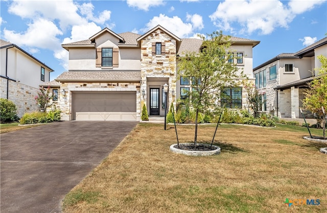 view of front facade featuring a garage and a front lawn