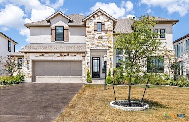 view of front of property featuring a front yard and a garage