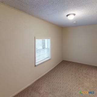 501 Live Oak St, Gatesville, TX 76528 - carpeted empty room featuring a textured ceiling