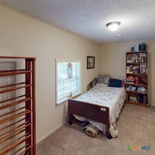 501 Live Oak St, Gatesville, TX 76528 - bedroom with a textured ceiling and carpet flooring