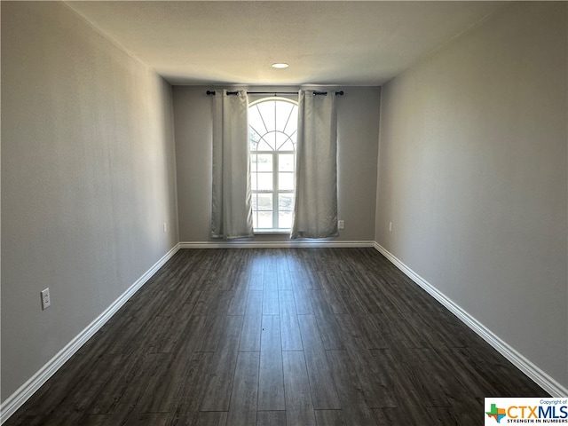 spare room featuring dark hardwood / wood-style flooring