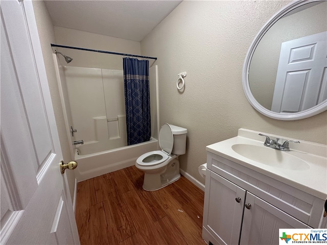 full bathroom featuring vanity, hardwood / wood-style flooring, toilet, and shower / tub combo with curtain