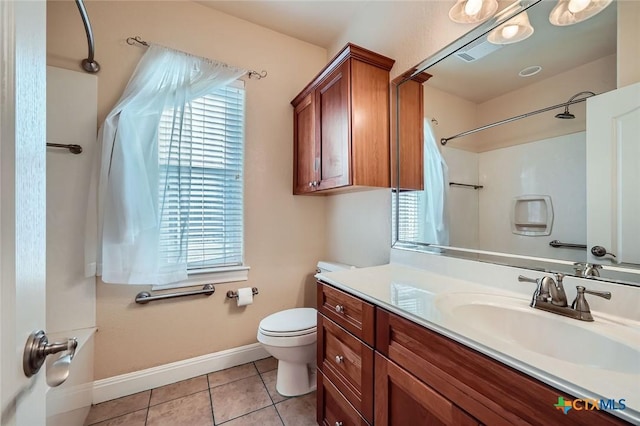 240 Hummingbird Way, Martindale, TX 78655 - full bathroom featuring toilet, vanity, a shower, tile patterned flooring, and baseboards