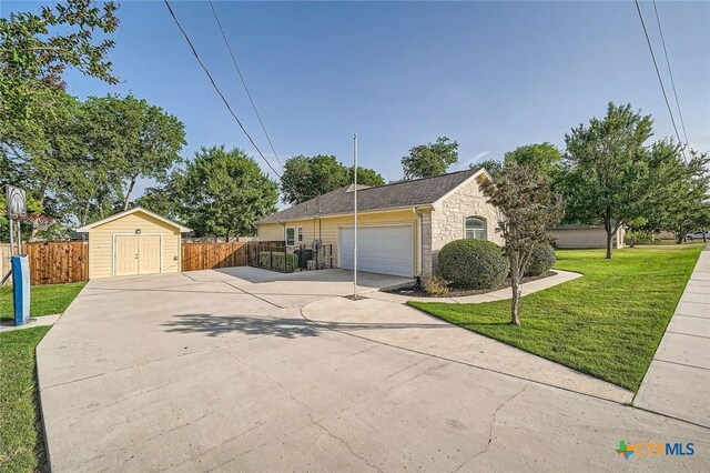 240 Hummingbird Way, Martindale, TX 78655 - view of front facade with concrete driveway, stone siding, and a garage