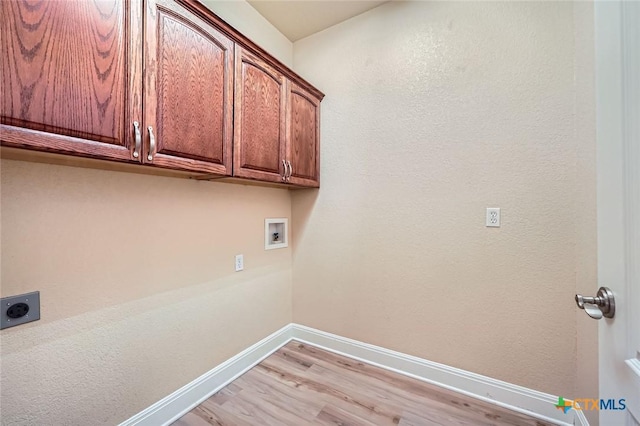 240 Hummingbird Way, Martindale, TX 78655 - laundry area with cabinet space, electric dryer hookup, light wood-style floors, washer hookup, and baseboards