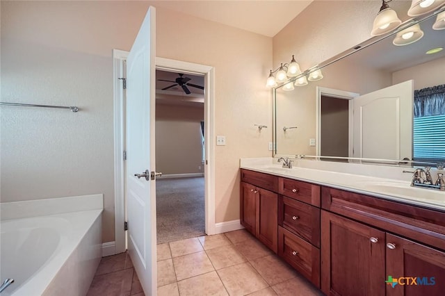 240 Hummingbird Way, Martindale, TX 78655 - full bath with double vanity, a bath, tile patterned floors, and baseboards