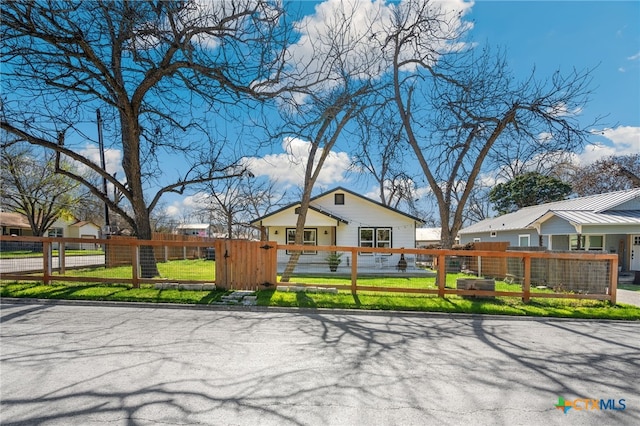 view of front facade with a fenced front yard and a gate