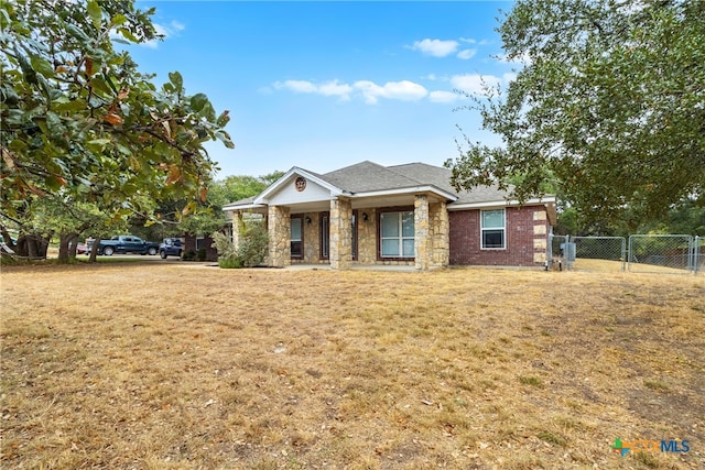 view of front of property featuring covered porch and a front lawn