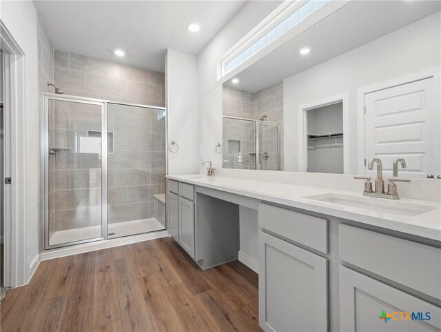 1513 Passmore Downs, New Braunfels, TX 78130 - bathroom featuring a shower stall, double vanity, a spacious closet, wood finished floors, and recessed lighting